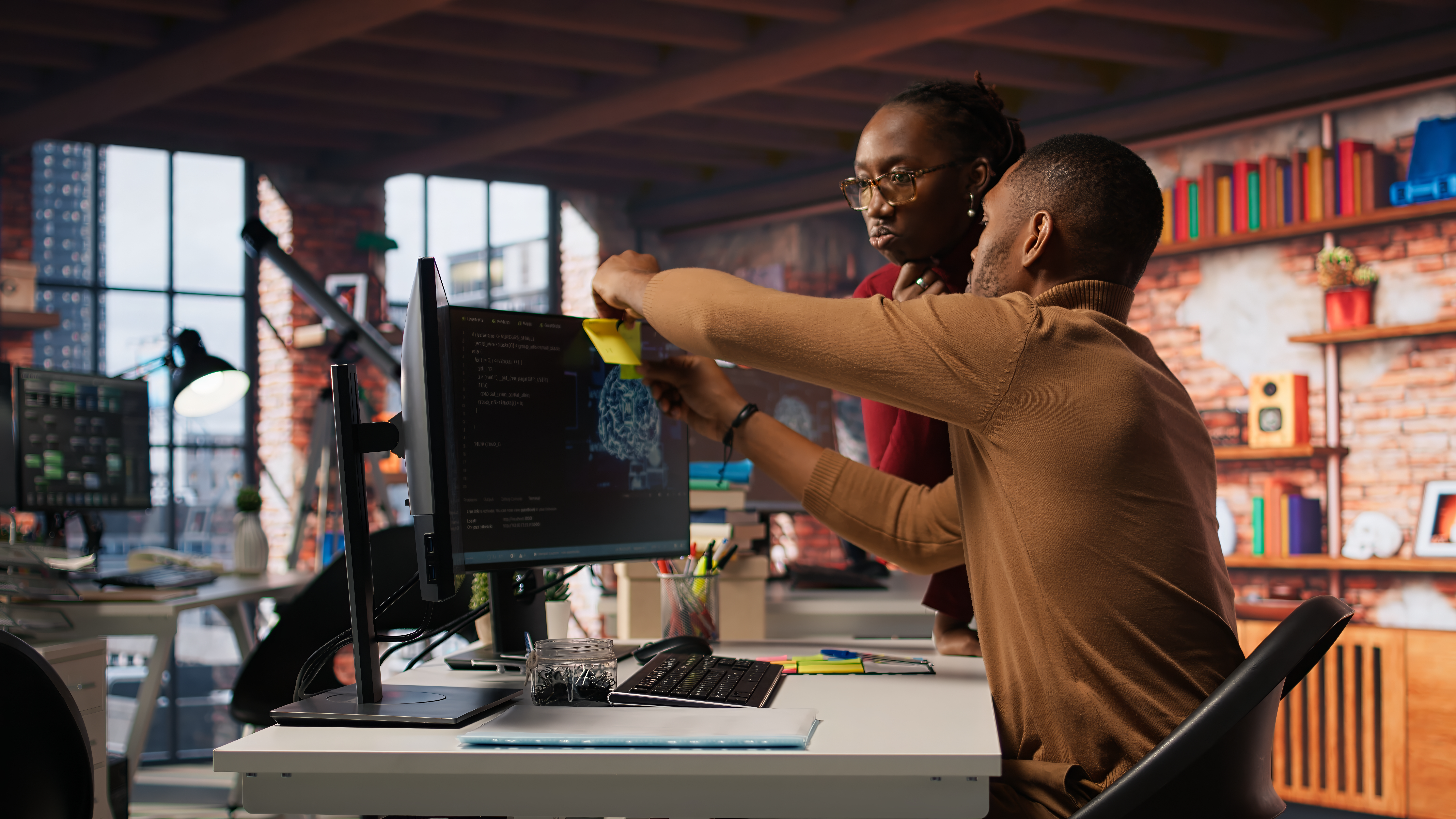 Black professional working on a laptop in a modern office